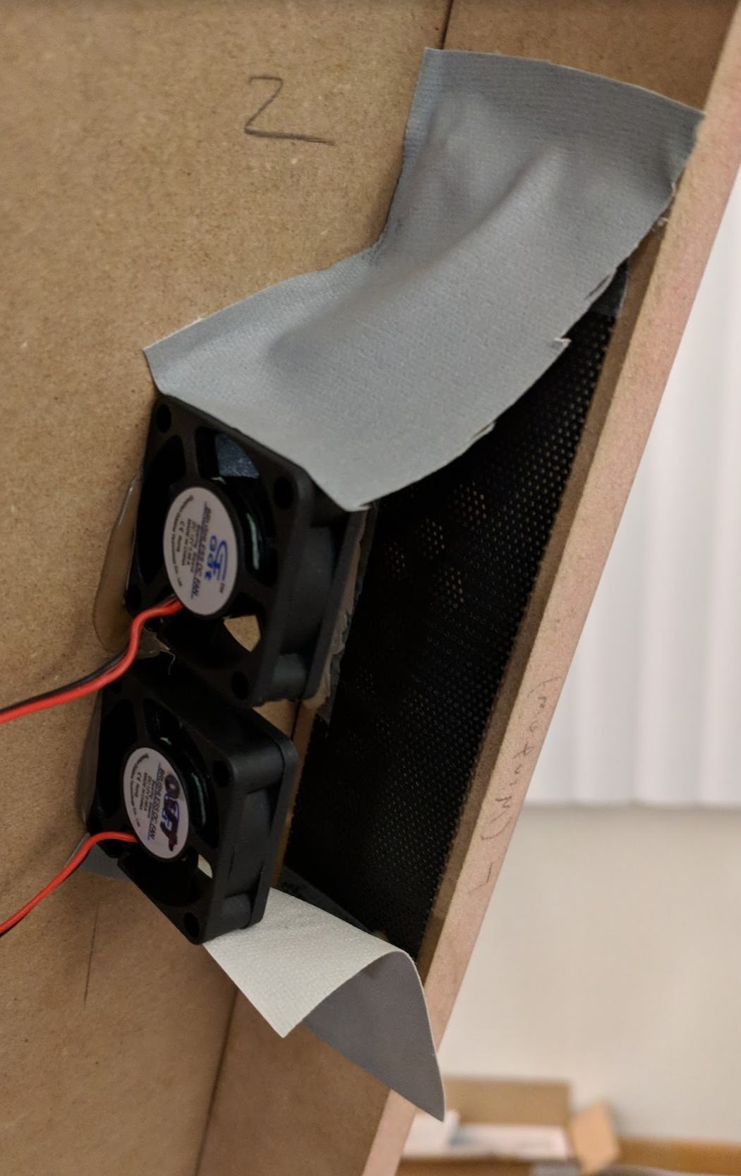 In-take fans on the side with some DIY ducting with some tape